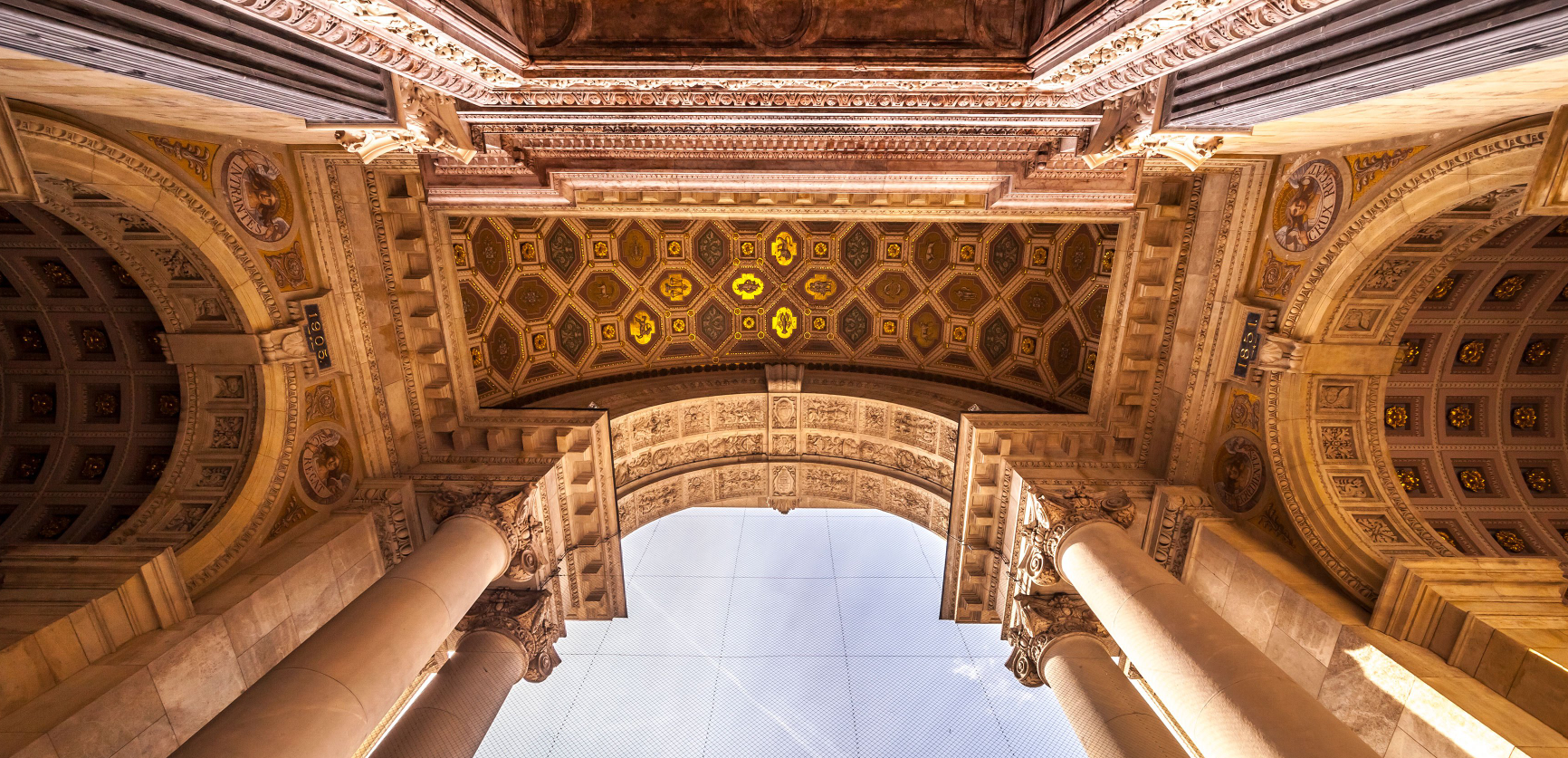 Ornate classical archway viewed from below